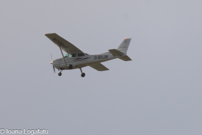 Small aircraft gliding through a cloudy sky